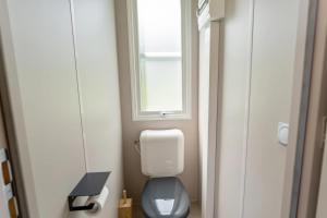 a small bathroom with a toilet and a window at Camping Papillon Bouillon - Vakantiehuis Relax 4P in Bouillon +17 photos