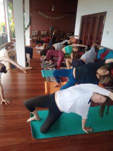 a group of people doing yoga in a room at The Tenthola in Kandy