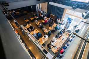 an overhead view of a crowd of people sitting at tables at Maison LeBreux - Motel in Petite-Vallée