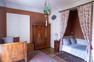 a bedroom with a bed and a window with curtains at Château de Choloy in Choloy