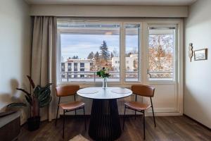 a table and chairs in a room with a window at Studio Esterinkatu in Imatra