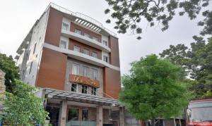 a building with a sign on the side of it at Starlight Hotels Palm Tree Mylapore Ramakrishna Mutt Road chennai in Chennai +13 photos