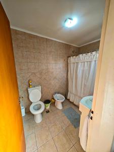 a bathroom with a toilet and a bidet at Depto AC Olavarria in Olavarría +1 photo