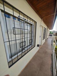 a building with barred windows and a walkway at Depto AC Olavarria in Olavarría