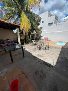 a backyard with a ping pong table and a pool at Suite in Catanduva