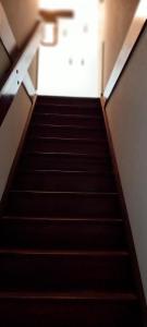 an escalator in a building with a stair case at Coquette maison in Dunkerque