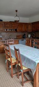 a kitchen with a table with chairs and a counter at Coquette maison in Dunkerque +20 photos