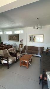 a living room with couches and a table at Residencial Marilis in Palhoça +103 photos