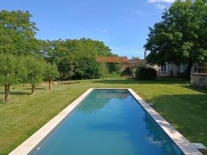a swimming pool in the yard of a house at Villa Paignon Gite in Montbron