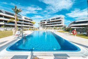 a swimming pool in front of a building at CasaBlanka Premium Apartment with Pool & Wellness in Torrevieja