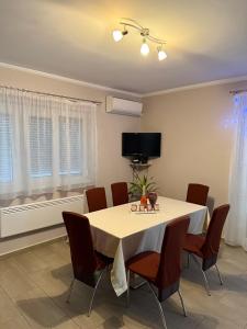 a dining room with a white table and chairs at Betti in Balatonkeresztúr +20 photos