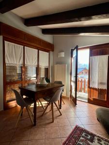 a dining room with a wooden table and chairs at Passeggiata al sole in Santa Maria Maggiore