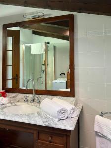 a bathroom with a sink and a mirror at Passeggiata al sole in Santa Maria Maggiore +7 photos