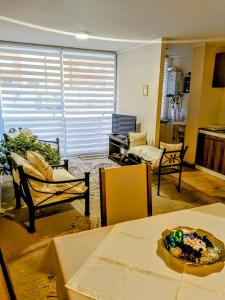 a living room with a table and chairs in a room at Chillan Centro in Chillán
