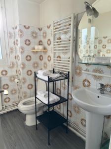 a bathroom with a toilet and a sink at CITY PARC HOTEL - Proche Paris Nord & CDG Aéroport - Parc des Expositions in Aulnay-sous-Bois