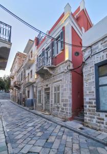a cobblestone street in an old building at The Urban Parrot Maisonette in Ermoupoli