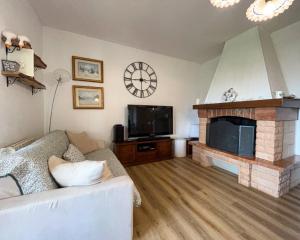 a living room with a couch and a fireplace at Home Nature and Relax in Monte del Lago