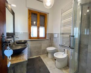a bathroom with a sink and a toilet at Home Nature and Relax in Monte del Lago +9 photos