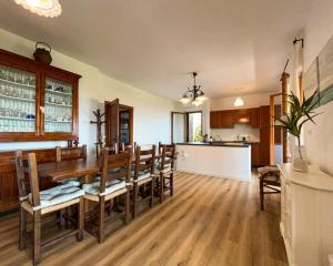 a kitchen and dining room with a wooden table and chairs at Home Nature and Relax in Monte del Lago