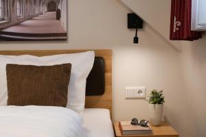 a bedroom with a bed with a pillow and a table at Doppelzimmer 10 in Heidenheim