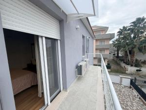 a balcony of a house with a bed and a window at Palazzo del Toro 2 in Montesilvano