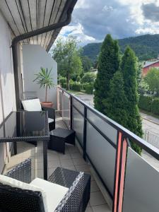 a balcony with chairs and a view of a street at HappyLivingApartments in Villach