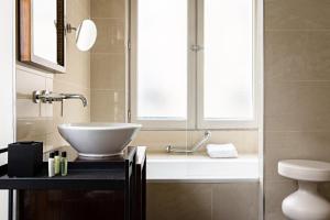 a bathroom with a bowl sink and a window at Holiday Inn Paris Palais de l'Elysée by IHG in Paris +70 photos