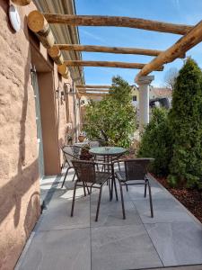 a patio with a table and chairs on a sidewalk at Appartement 1 mit Terrasse in Wehlenberg