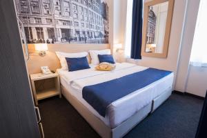 a bedroom with a large bed with blue pillows at Five Points Square - City Center in Belgrade +38 photos