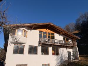 a white building with a balcony on top of it at Gruberhof in Pill
