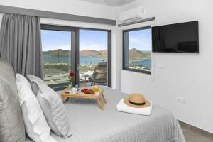 a bedroom with a bed with a view of the ocean at Sole Mare Luxury Villa With Sea View & Private Pool in Elounda in Elounda