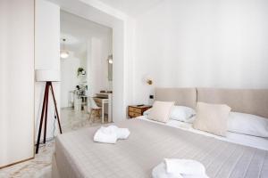 a bedroom with a large bed with towels on it at AuGuStea - Modern Central Suites in Bari