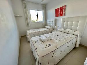 a room with three beds and a window at Plaza España - Central 3 Bedroom apartment - LUAL in Nerja +33 photos
