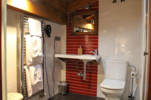 a small bathroom with a toilet and a sink at Casa Rural Las Bodegas II in Valbuena de Duero +9 photos