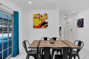 a dining room with a wooden table and chairs at Relax & Fun Hollywood Private Pool | Arcade Game in Hollywood +38 photos