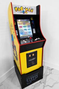 a arcade video game machine sitting on top of a counter at Relax & Fun Hollywood Private Pool | Arcade Game in Hollywood