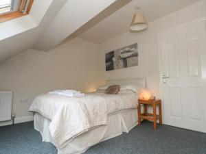a bedroom with a bed with a cat laying on it at Cragg Hall View in Mytholmroyd