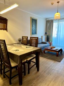 a living room with a table and chairs and a couch at HappyLivingApartments in Villach