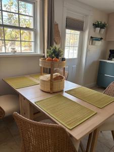 a dining room table with baskets of oranges on it at LasPalmas Beach Rentals,3 in Bradenton Beach