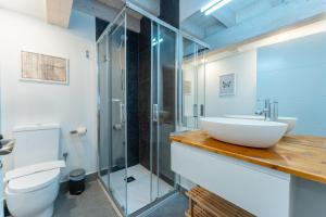 a bathroom with a sink and a glass shower at Sandoñana Old Palace Lodge in Villafufre +172 photos
