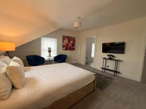 a bedroom with a large bed and a flat screen tv at The Loft Ashley Road in Poole