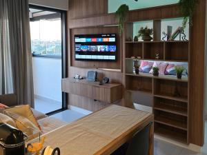 a room with a table and a tv in a room at Emilie Home in Sao Jose do Rio Preto