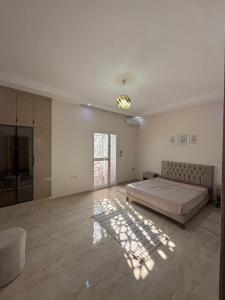 a large bedroom with a bed and a window at Dar Lina in Tozeur