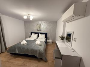 a bedroom with a bed with two towels on it at Villa Solina in Sapareva Banya