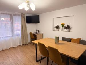 a dining room with a wooden table and chairs at Villa Solina in Sapareva Banya
