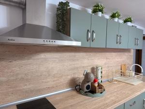 a kitchen with white cabinets and a stove top oven at Villa Solina in Sapareva Banya +5 photos