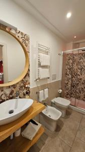 a bathroom with a sink and a toilet and a mirror at B&B Triskèles in Giardini Naxos +32 photos