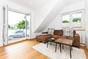 a living room with a couch and a table at Alte Molkerei in Esens