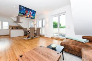 a living room with a couch and a table at Alte Molkerei in Esens +23 photos