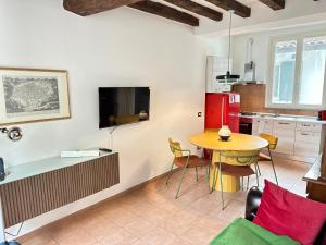 a kitchen with a table and a dining room at Dimora Pia in Piacenza